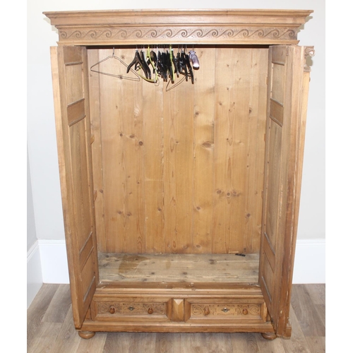 30 - A large impressive antique wardrobe with profusely carved details and ionic column supports, 2 doors... 