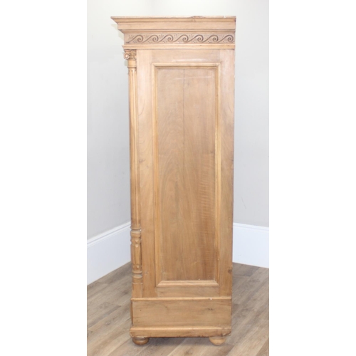 30 - A large impressive antique wardrobe with profusely carved details and ionic column supports, 2 doors... 