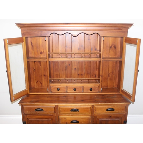 26 - A modern pine dresser, the base with 4 central drawers flanked by a drawer over a cupboard, the top ... 