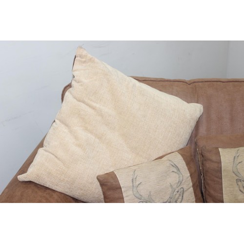 37 - A good quality modern brown suede leather sofa and a number of decorative cushions, approx 222cm wid... 