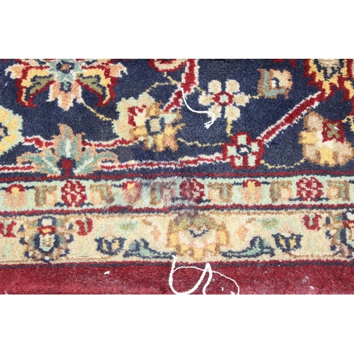 217 - An extremely large red ground Persian rug, approx 420cm x 305cm