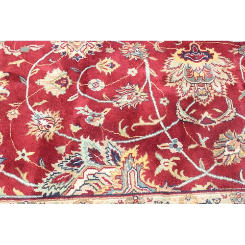 217 - An extremely large red ground Persian rug, approx 420cm x 305cm