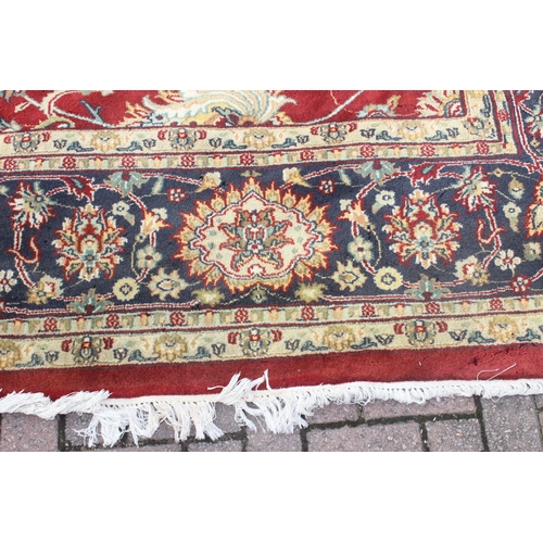 217 - An extremely large red ground Persian rug, approx 420cm x 305cm