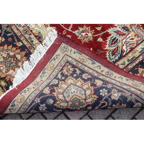 217 - An extremely large red ground Persian rug, approx 420cm x 305cm