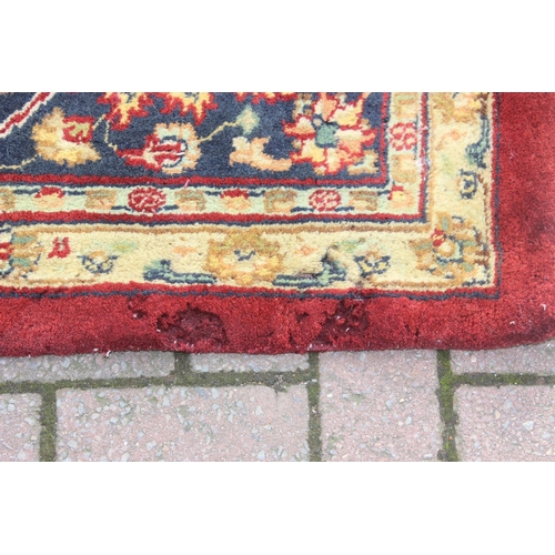 217 - An extremely large red ground Persian rug, approx 420cm x 305cm