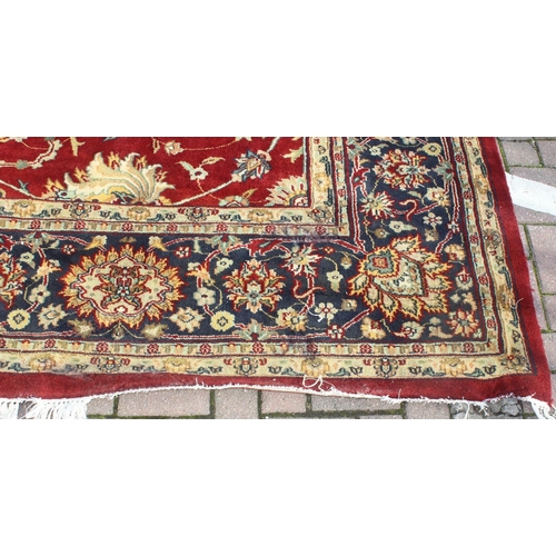 217 - An extremely large red ground Persian rug, approx 420cm x 305cm