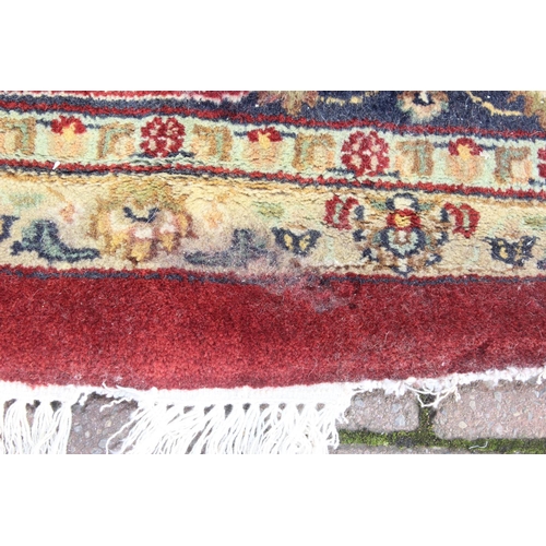 217 - An extremely large red ground Persian rug, approx 420cm x 305cm