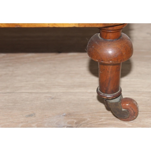 55 - A 19th century walnut canterbury whatnot with turned spindle supports, the canterbury with three sec... 