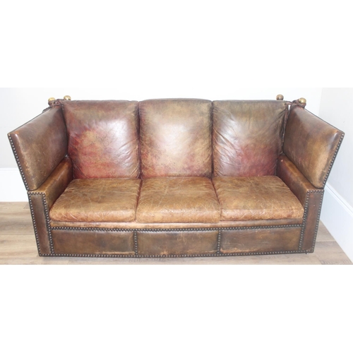 59 - A good quality antique style brown leather Knole sofa with drop ends, brass ball finials with knotte... 