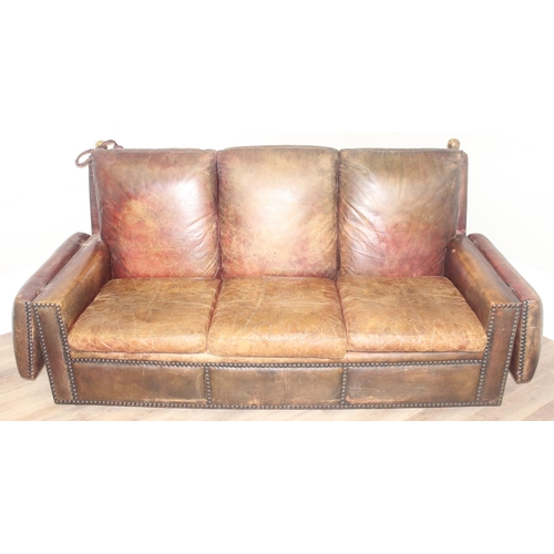 59 - A good quality antique style brown leather Knole sofa with drop ends, brass ball finials with knotte... 