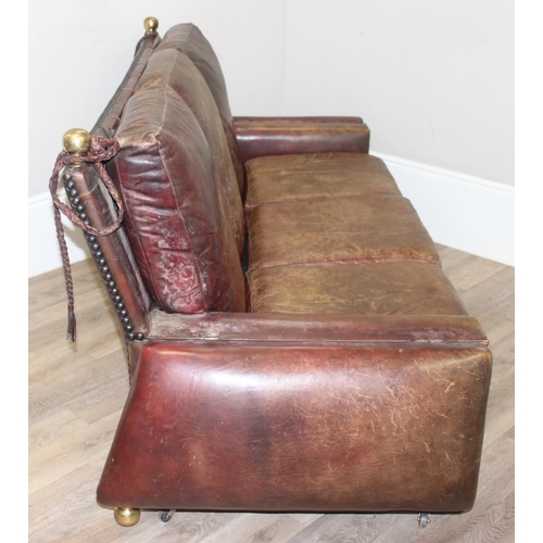 59 - A good quality antique style brown leather Knole sofa with drop ends, brass ball finials with knotte... 