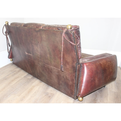 59 - A good quality antique style brown leather Knole sofa with drop ends, brass ball finials with knotte... 