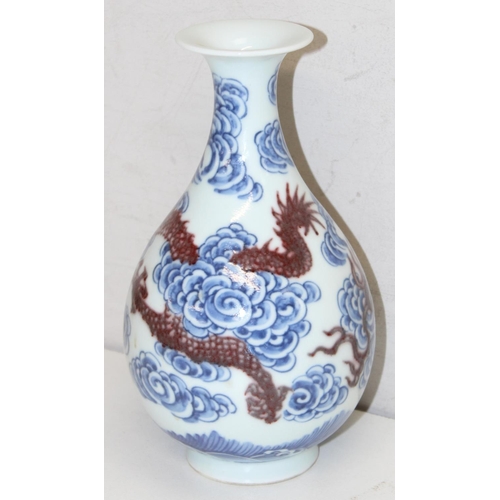 1569 - Chinese blue and white porcelain vase with a red dragon design, with 6-character Kangxi marks to bas... 