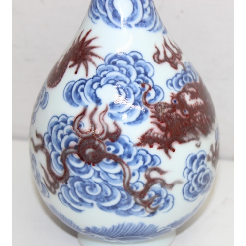 1569 - Chinese blue and white porcelain vase with a red dragon design, with 6-character Kangxi marks to bas... 