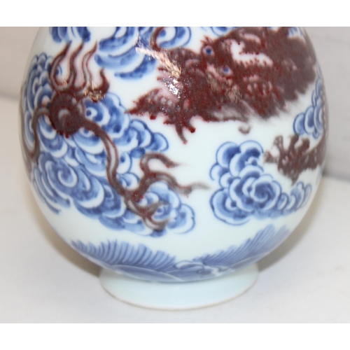 1569 - Chinese blue and white porcelain vase with a red dragon design, with 6-character Kangxi marks to bas... 