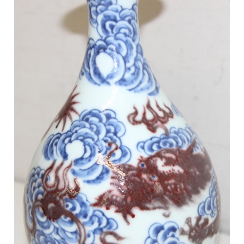 1569 - Chinese blue and white porcelain vase with a red dragon design, with 6-character Kangxi marks to bas... 