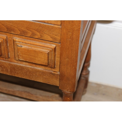 161 - Antique style stained beech bedside table with 2 drawers and iron drop handles, approx 62cm x 37cm x... 