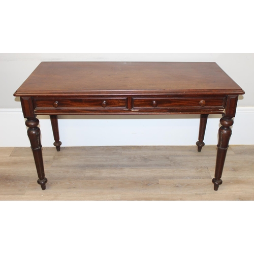 153 - A 19th century mahogany hall table or desk with 2 drawers, turned wooden handles and impressive carv... 