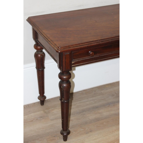 153 - A 19th century mahogany hall table or desk with 2 drawers, turned wooden handles and impressive carv... 