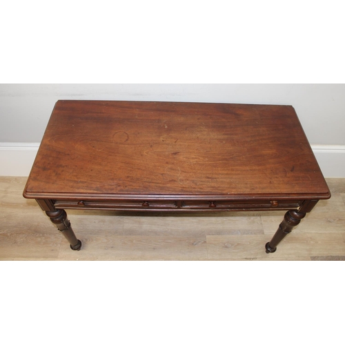 153 - A 19th century mahogany hall table or desk with 2 drawers, turned wooden handles and impressive carv... 