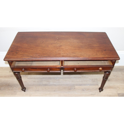 153 - A 19th century mahogany hall table or desk with 2 drawers, turned wooden handles and impressive carv... 