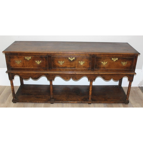 137 - A George III style oak 3 drawer sideboard or dresser base with brass handles, approx 185cm wide x 51... 