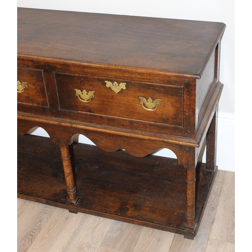 137 - A George III style oak 3 drawer sideboard or dresser base with brass handles, approx 185cm wide x 51... 