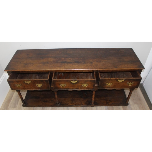 137 - A George III style oak 3 drawer sideboard or dresser base with brass handles, approx 185cm wide x 51... 