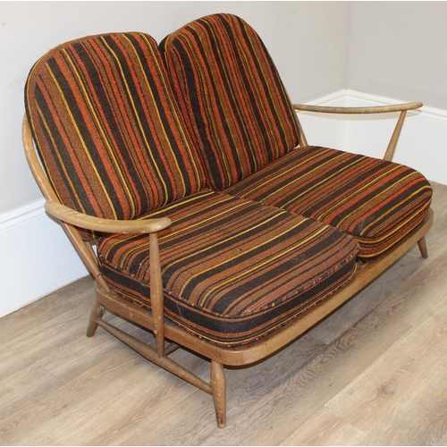 6 - Ercol - a retro 2 seater sofa with mid-century coloured cushions, believed to be a model 203 from th... 