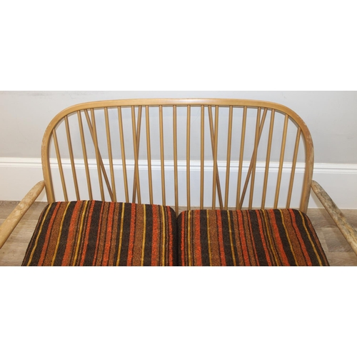 6 - Ercol - a retro 2 seater sofa with mid-century coloured cushions, believed to be a model 203 from th... 