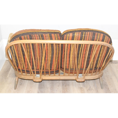 6 - Ercol - a retro 2 seater sofa with mid-century coloured cushions, believed to be a model 203 from th... 