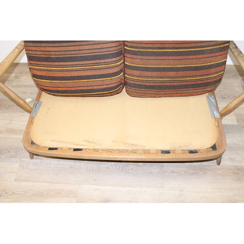 6 - Ercol - a retro 2 seater sofa with mid-century coloured cushions, believed to be a model 203 from th... 