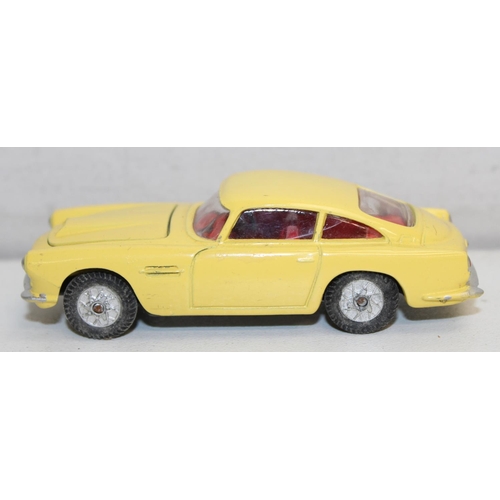 680 - Vintage Corgi Toys Aston Martin D.B.4 (218) diecast scale model in yellow with red interior, with or... 