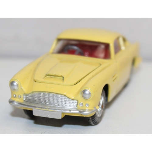 680 - Vintage Corgi Toys Aston Martin D.B.4 (218) diecast scale model in yellow with red interior, with or... 