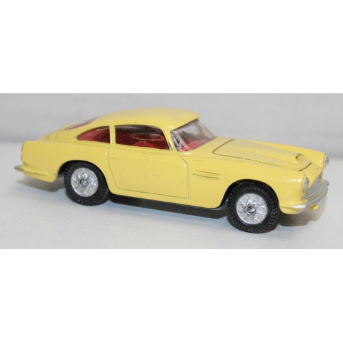 680 - Vintage Corgi Toys Aston Martin D.B.4 (218) diecast scale model in yellow with red interior, with or... 