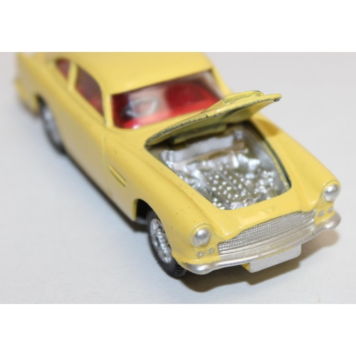 680 - Vintage Corgi Toys Aston Martin D.B.4 (218) diecast scale model in yellow with red interior, with or... 