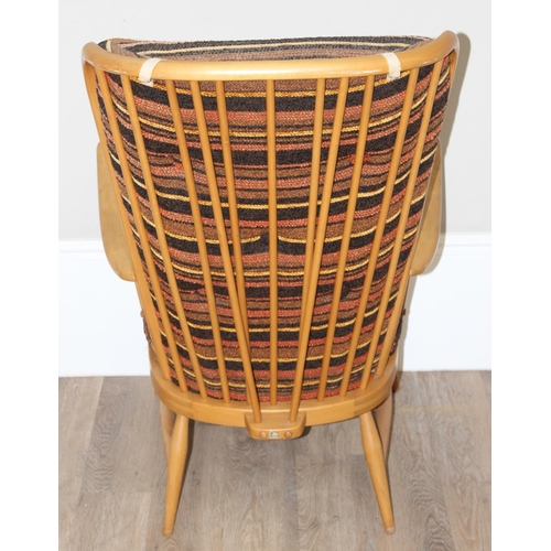 7 - Ercol - a retro high backed armchair with mid-century coloured cushions, believed to be a model 478 ... 