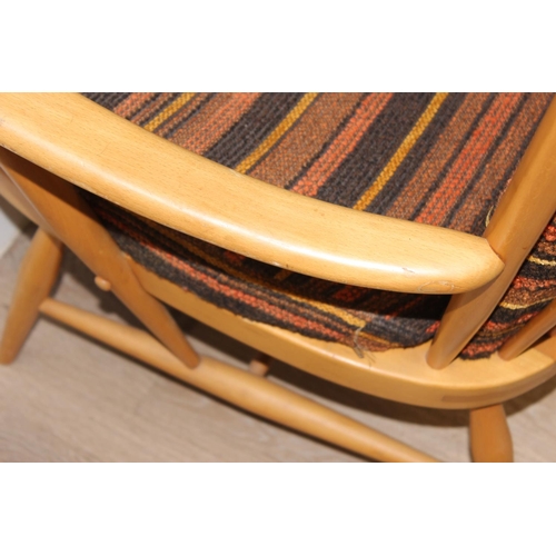 7 - Ercol - a retro high backed armchair with mid-century coloured cushions, believed to be a model 478 ... 