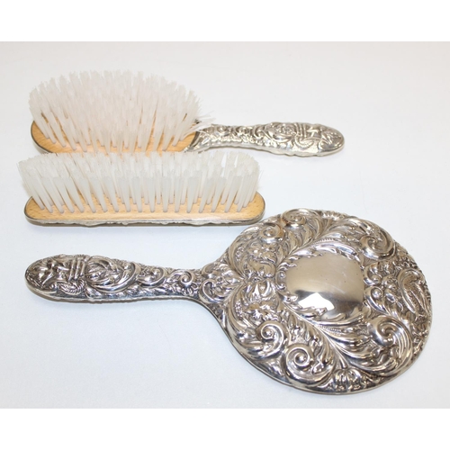 1047 - A boxed Sterling silver mounted 3 piece dressing table set comprising of a hand mirror, a hair brush... 