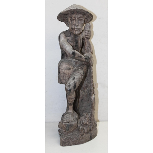 1671 - A large Oriental carved hardwood figure of a fisherman and a pottery model of a horses head, the lar... 