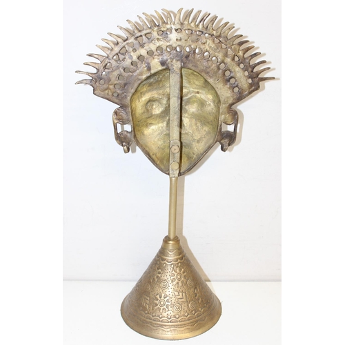 1672 - A pair of brass Incan sun god masks on conical bases, 20th century, each approx 42cm tall