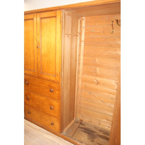 61 - A Victorian hall or housekeepers cupboard of large proportions, either satinwood or pine, a large co... 