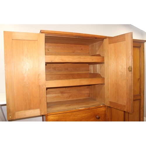 61 - A Victorian hall or housekeepers cupboard of large proportions, either satinwood or pine, a large co... 