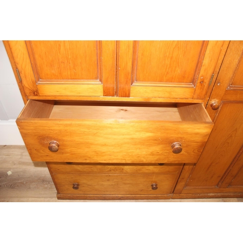 61 - A Victorian hall or housekeepers cupboard of large proportions, either satinwood or pine, a large co... 