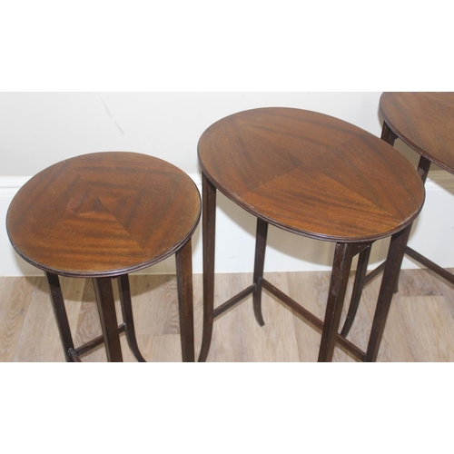 70 - A vintage mahogany nest of 3 tables and a mahogany drop leaf table, the largest of the nest of table... 