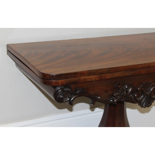 156 - A William IV period mahogany card table with carved details and a pillars support, green baize lined... 