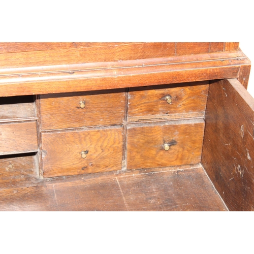 155 - A late 18th or early 19th century oak cabinet on stand, the top 2 door cabinet with 2 shelves, the 3... 