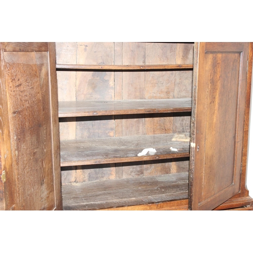 155 - A late 18th or early 19th century oak cabinet on stand, the top 2 door cabinet with 2 shelves, the 3... 