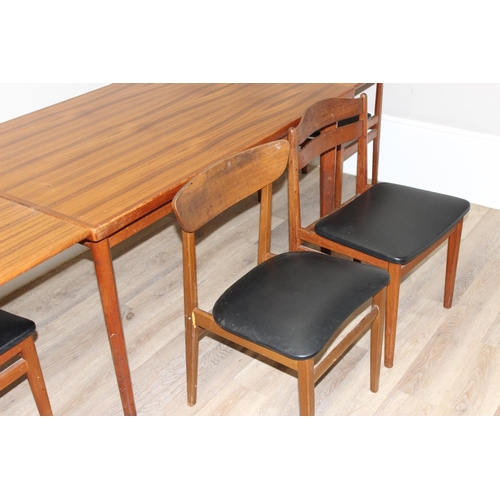 151 - A retro extending dining table and a set of 4 harlequin matched retro dining chairs, all pieces seem... 