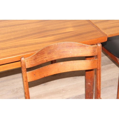 151 - A retro extending dining table and a set of 4 harlequin matched retro dining chairs, all pieces seem... 